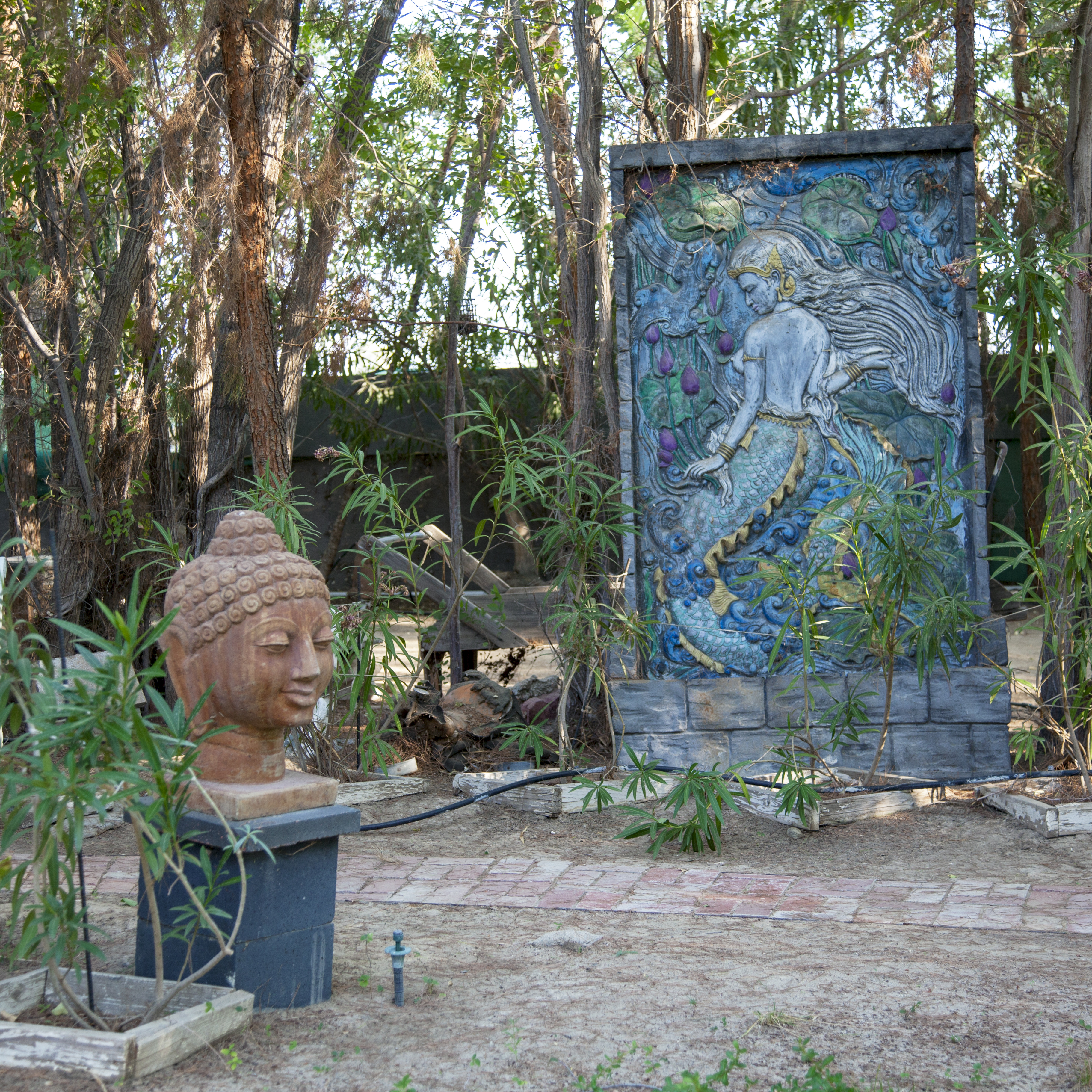 Carved mermaid and Buddha head